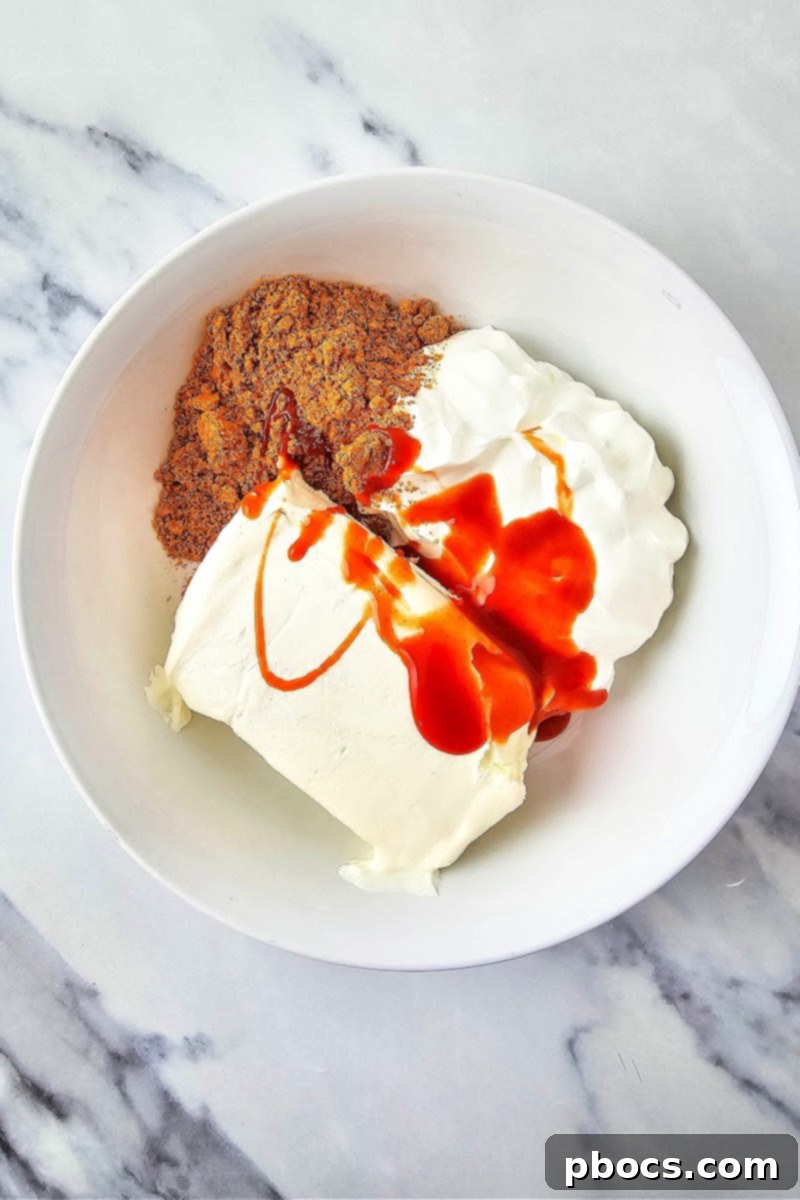 Mixing the cream cheese with taco seasoning