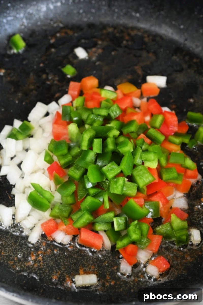 Sautéing onions and peppers in a skillet