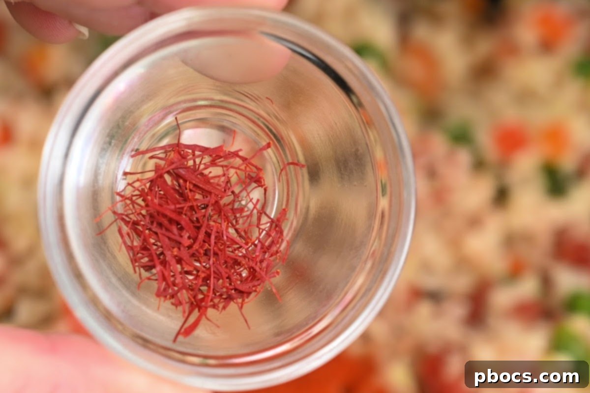 Saffron thread added to the simmering paella