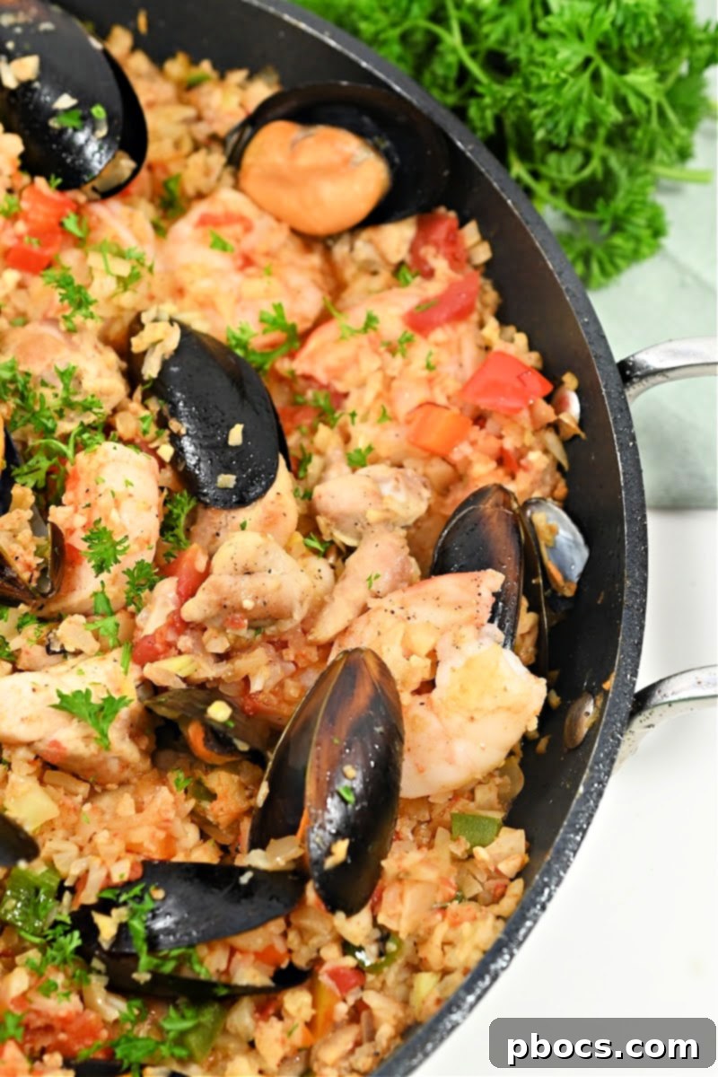 Close-up of traditional paella ingredients cooking in a skillet