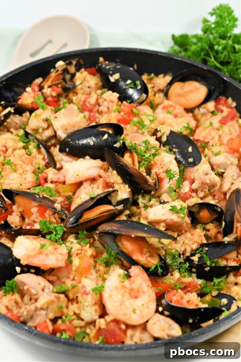 Leftover Keto Paella stored in an airtight container in the refrigerator