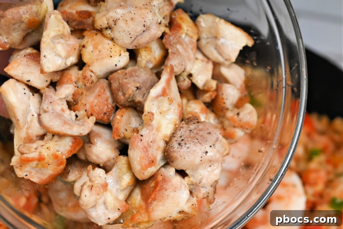 Cooked chicken thigh pieces in a skillet