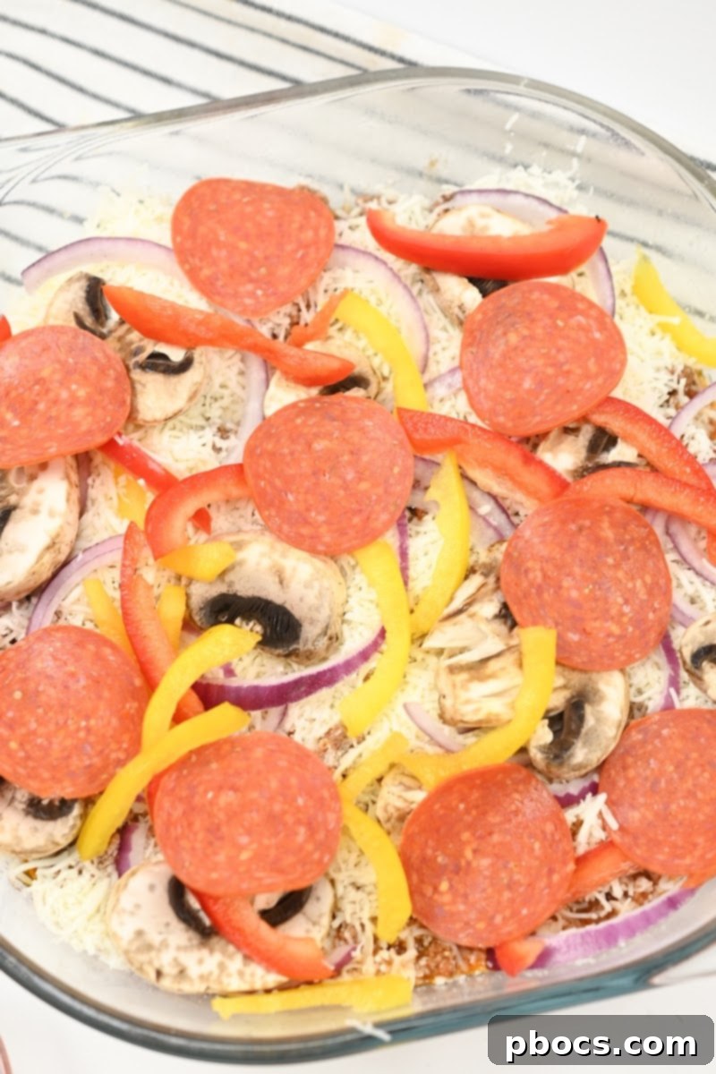 Keto Beef Pizza Bake 11 Adding pepperoni slices to the casserole