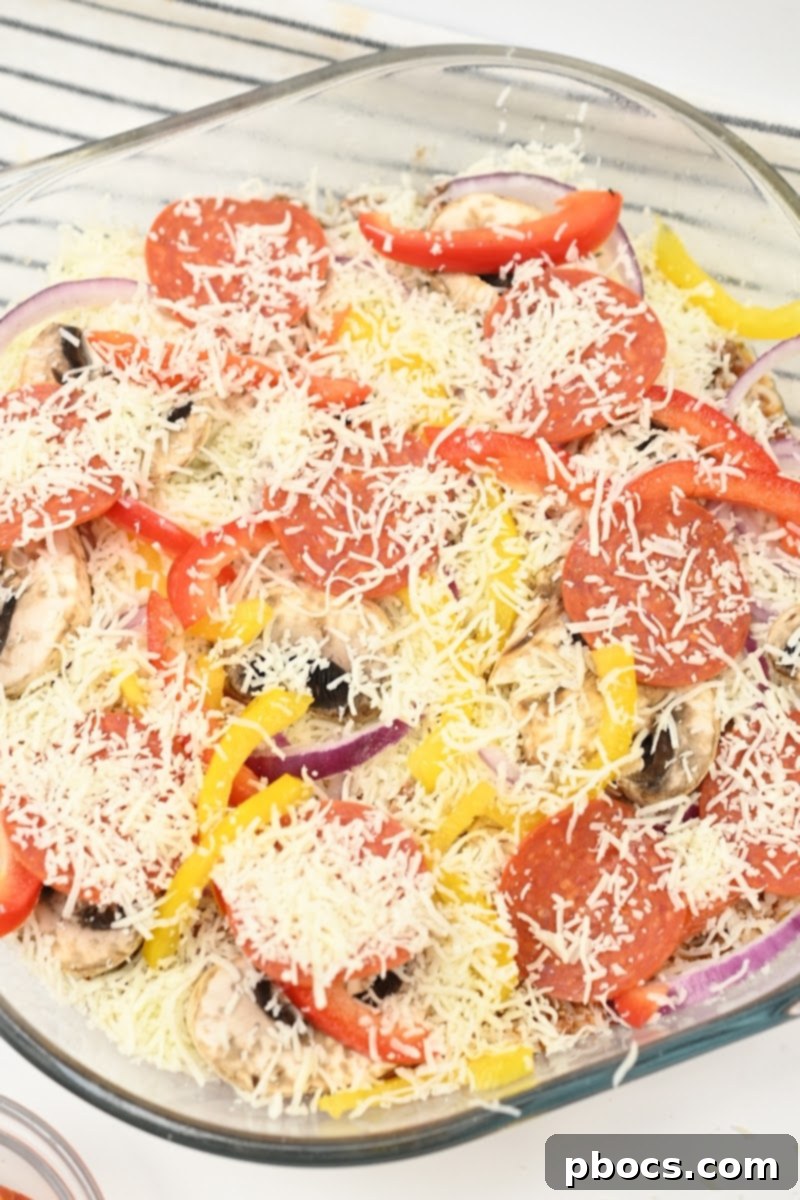 Keto Beef Pizza Bake 12 Sprinkling remaining mozzarella cheese on top