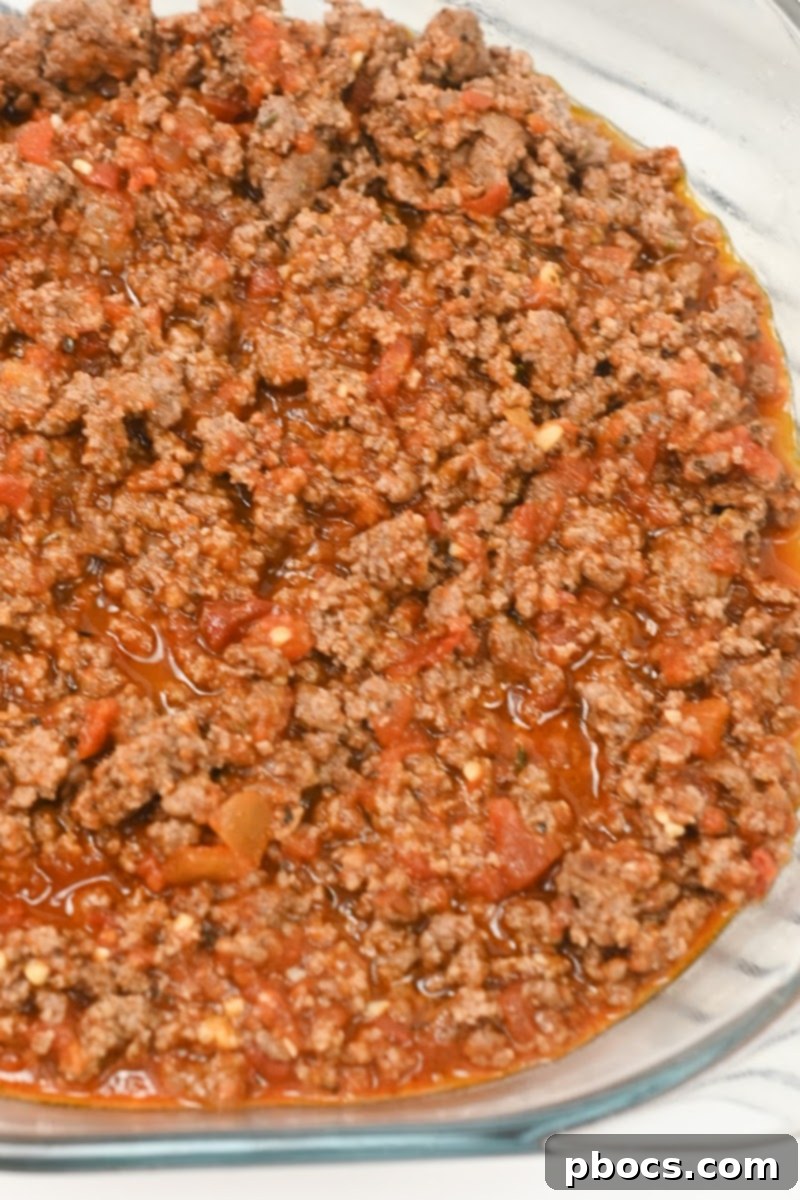 Keto Beef Pizza Bake 10 Ground beef mixture spread in a casserole dish