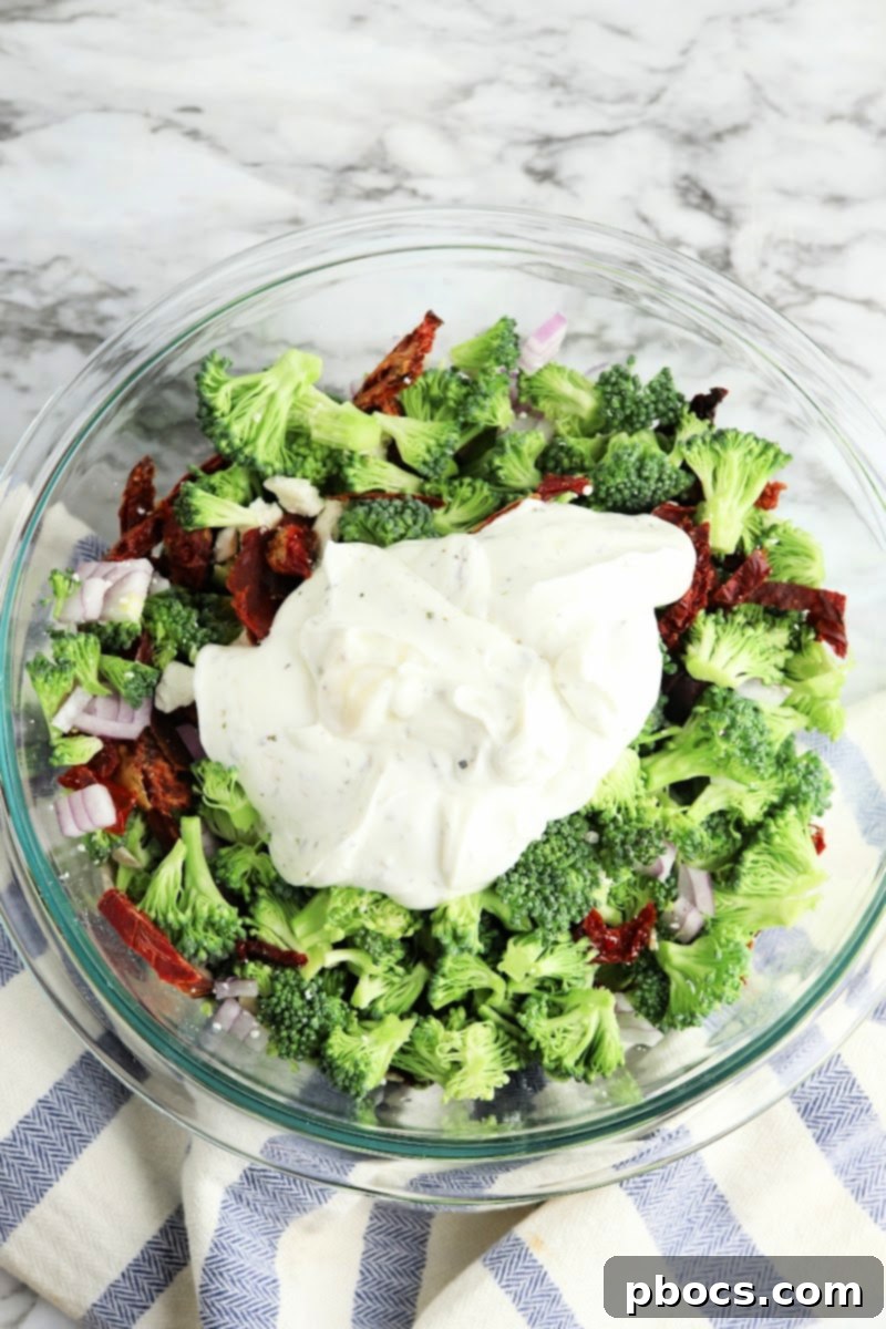 Adding the dressing to the broccoli salad