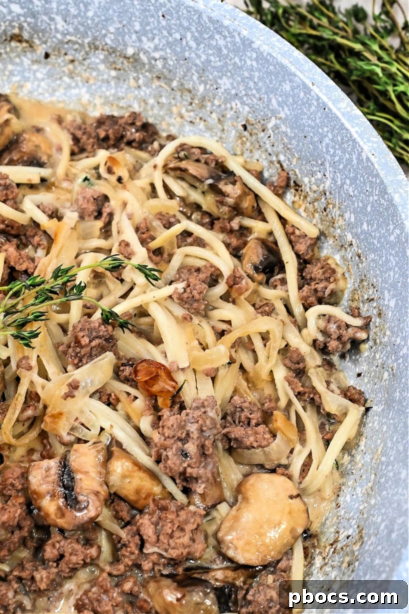 Serving of Keto Creamy TikTok French Onion Pasta garnished with fresh thyme