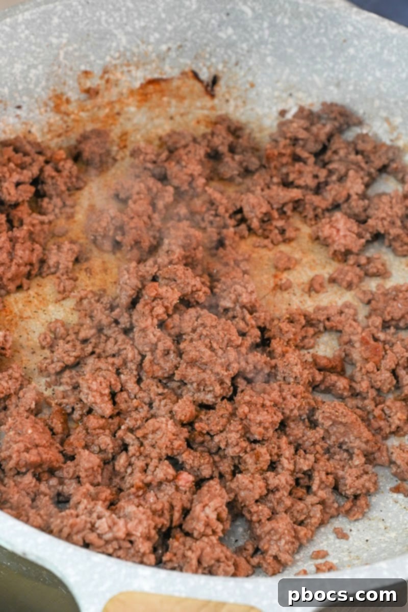 Ground beef browning in a skillet for the pasta dish