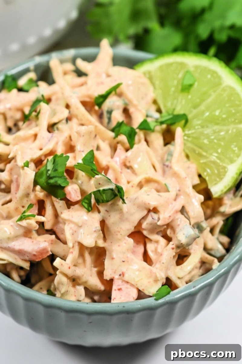 A bowl of Keto Mexican Coleslaw being stored in the fridge
