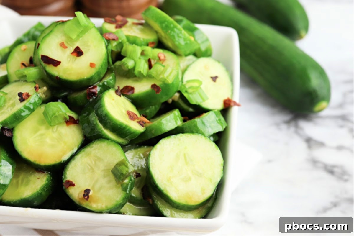 Vibrant Korean Cucumber Salad 11 A bowl of finished Keto Korean Cucumber Salad, garnished with the remaining green onions and a sprinkle of red pepper flakes, ready to be enjoyed
