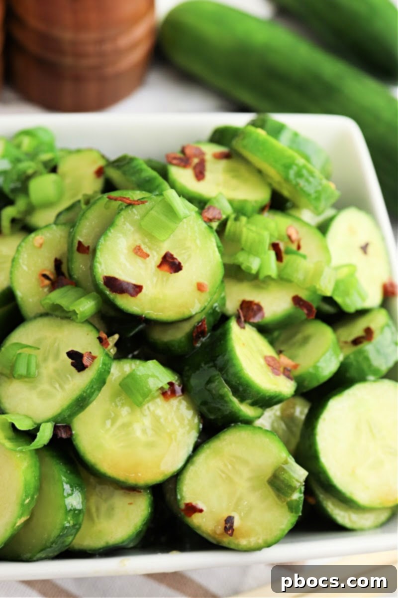 Vibrant Korean Cucumber Salad 5 Keto Korean Cucumber Salad garnished with extra red pepper flakes and green onions, ready to be served