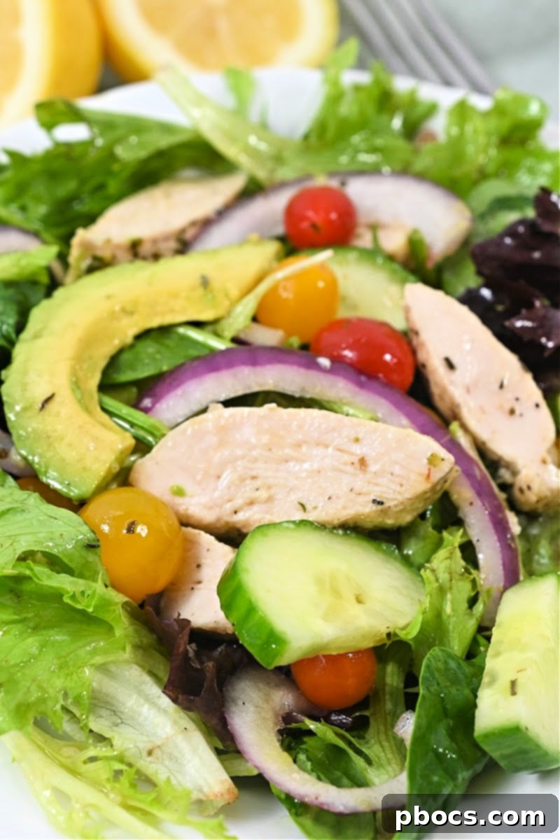 Keto Lemon Herb Chicken Salad - A vibrant dish featuring grilled lemon herb chicken, fresh greens, and colorful toppings.