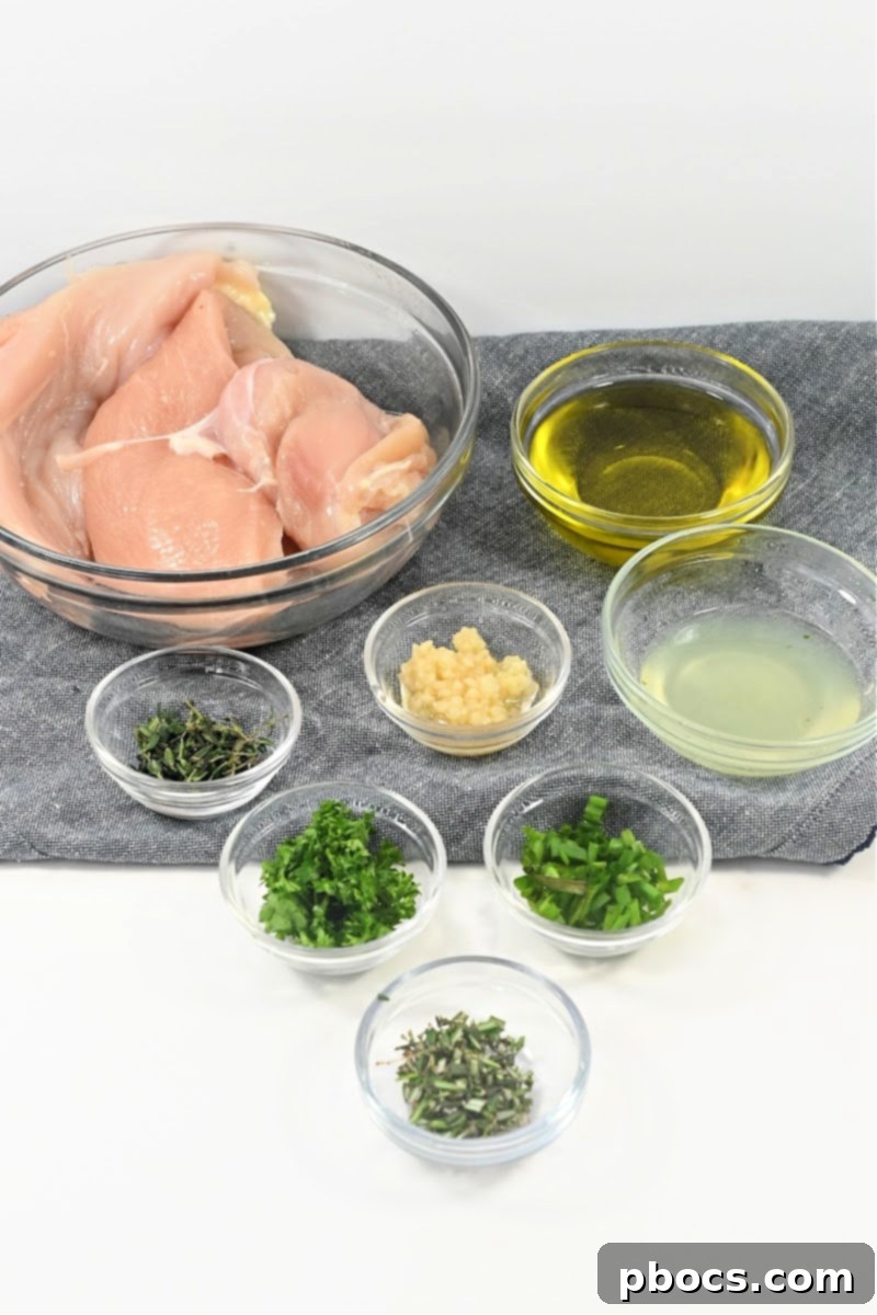 Ingredients for Chicken Marinade - Fresh herbs, lemon, garlic, olive oil, and chicken.