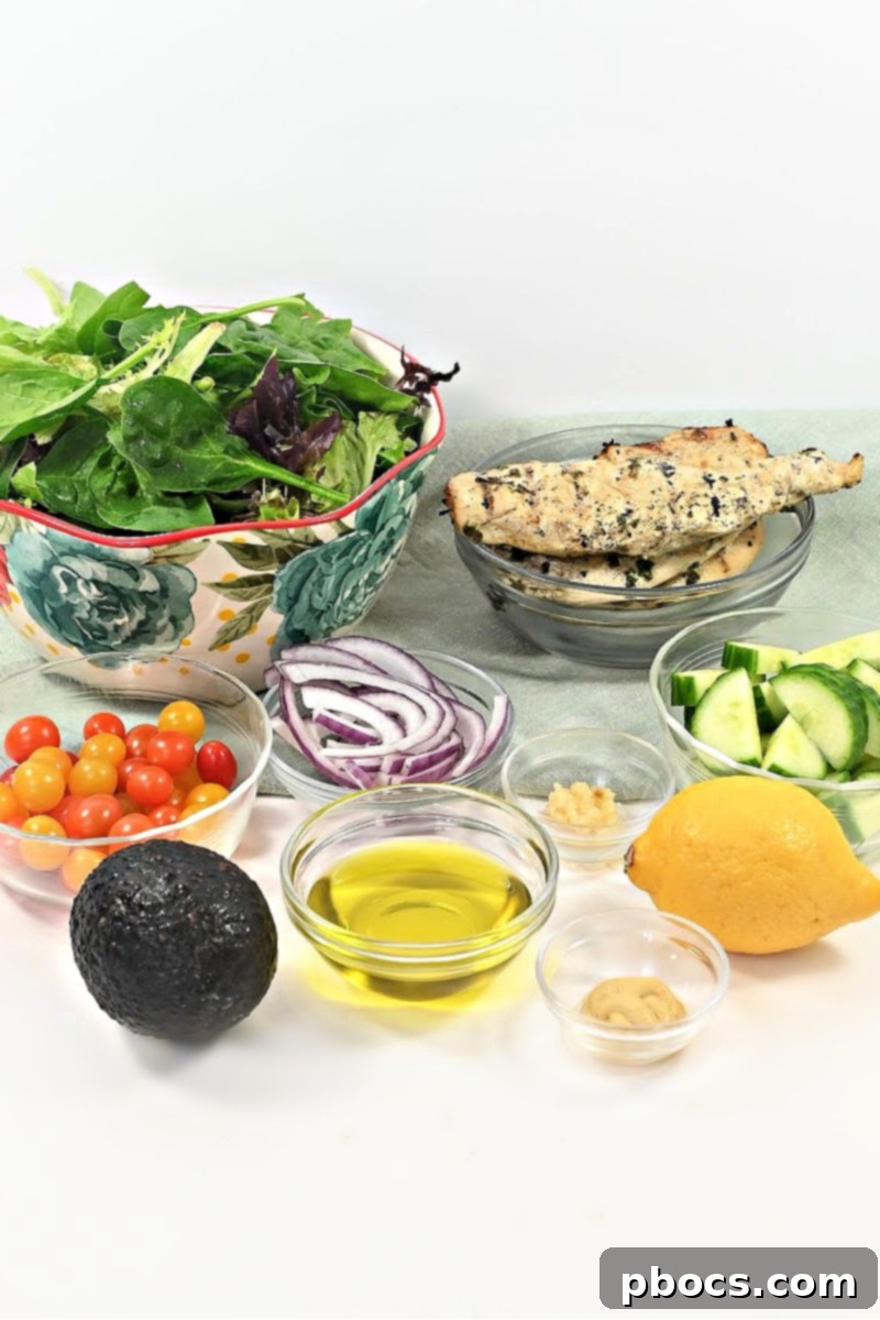 Keto Lemon Herb Chicken Salad Toppings - Mixed greens, tomatoes, cucumber, red onion, avocado.
