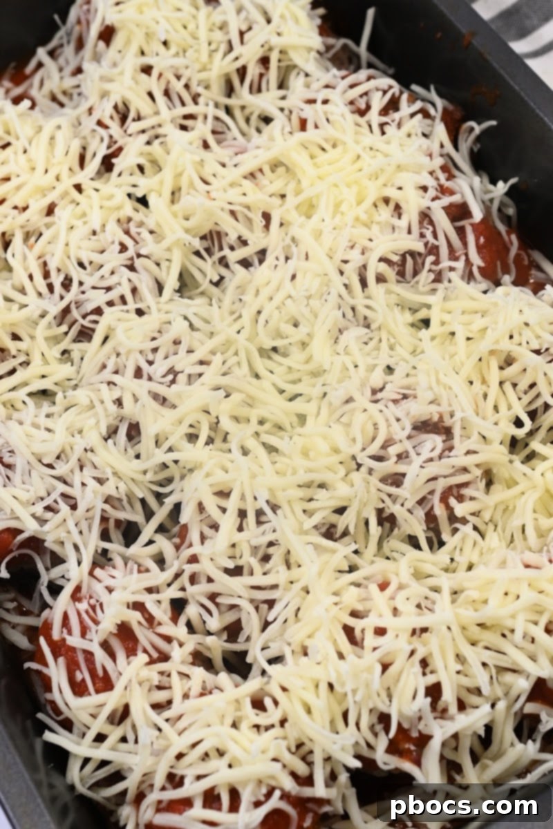 Topping meatballs with shredded cheese