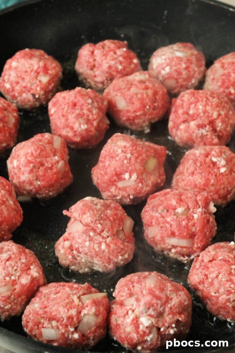 Raw meatballs in a skillet