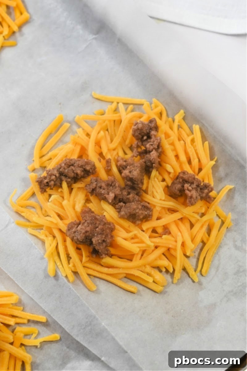 Big Mac Keto Cheese Crunchers 10 Seasoned ground beef being sprinkled over circles of shredded cheddar cheese.
