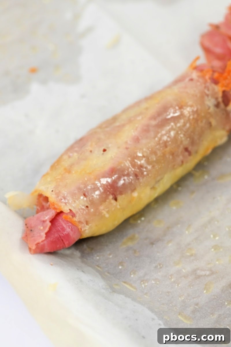 Rolling the cheese wrap around the Reuben ingredients