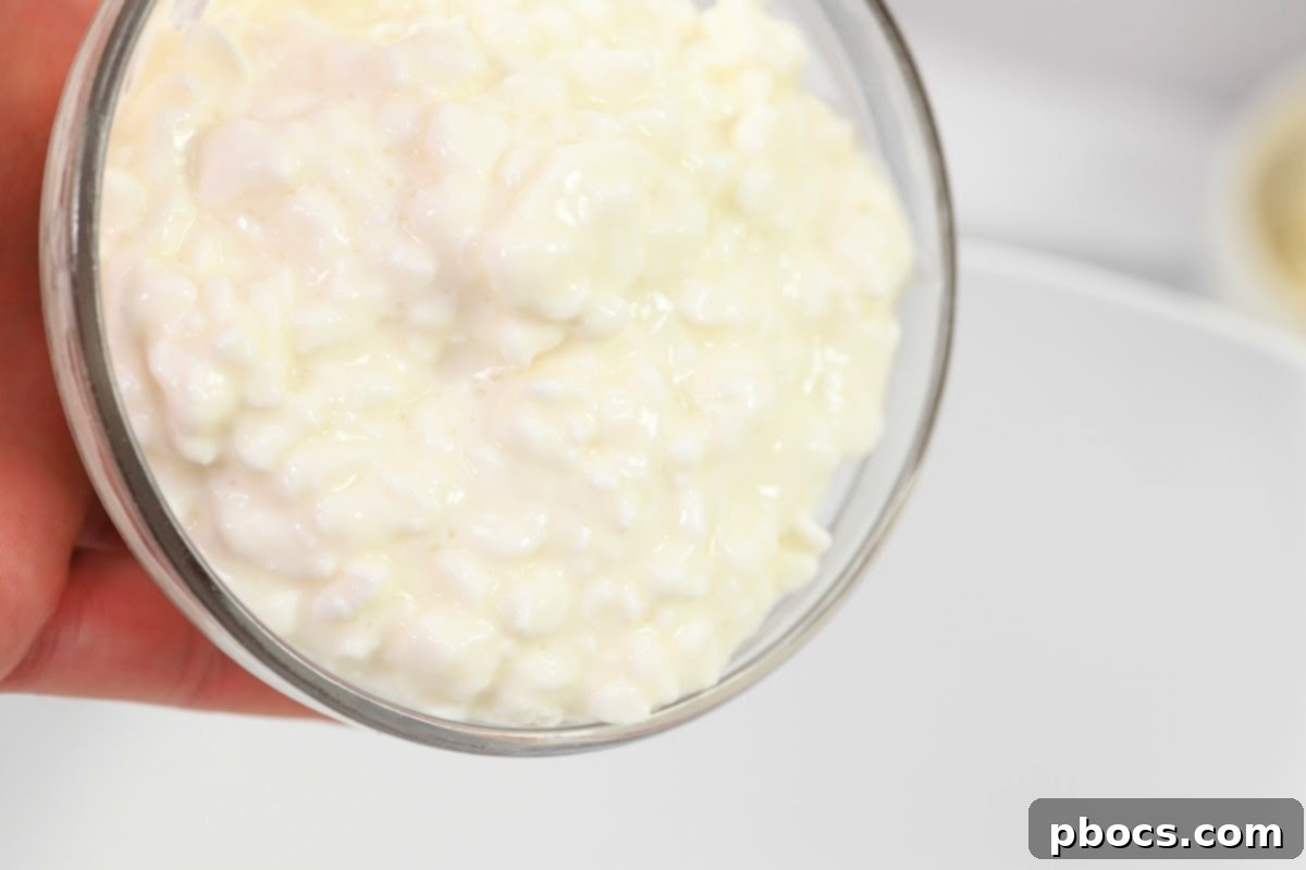 Cottage cheese, marinara sauce, and Italian seasoning being whisked in a bowl