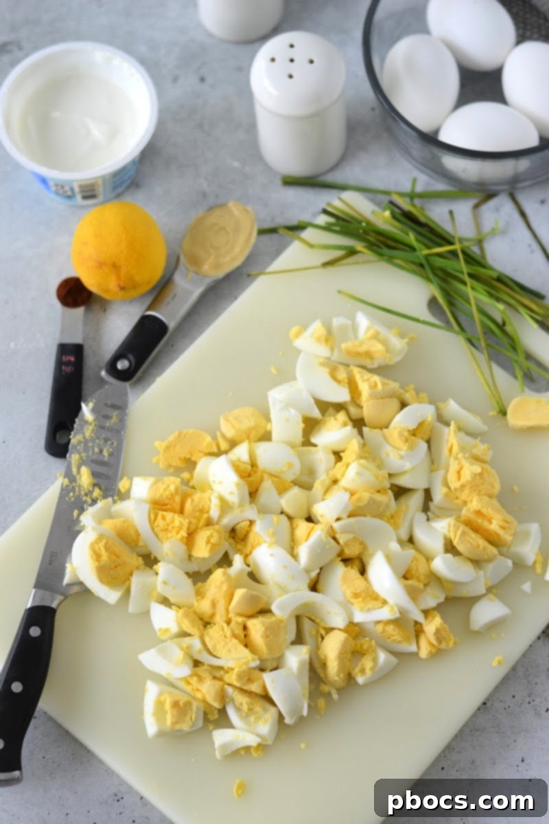 Mediterranean Greek Yogurt Egg Salad 9 Chopping up hard boiled eggs
