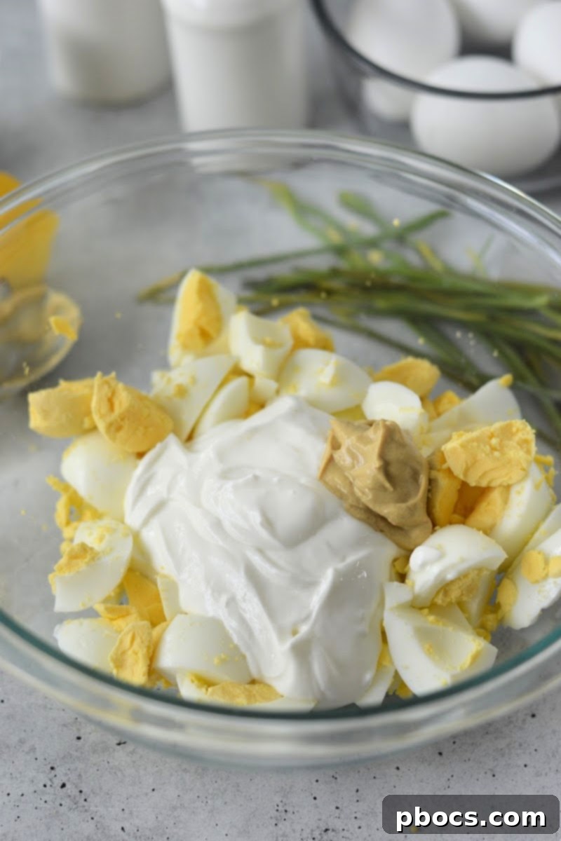 Mediterranean Greek Yogurt Egg Salad 10 Adding mayo and mustard to egg salad