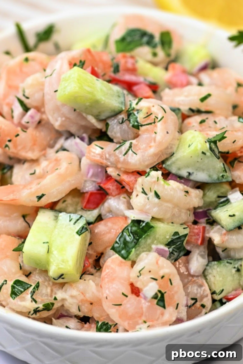 Close-up of Creamy Shrimp and Cucumber Salad with fresh dill garnish