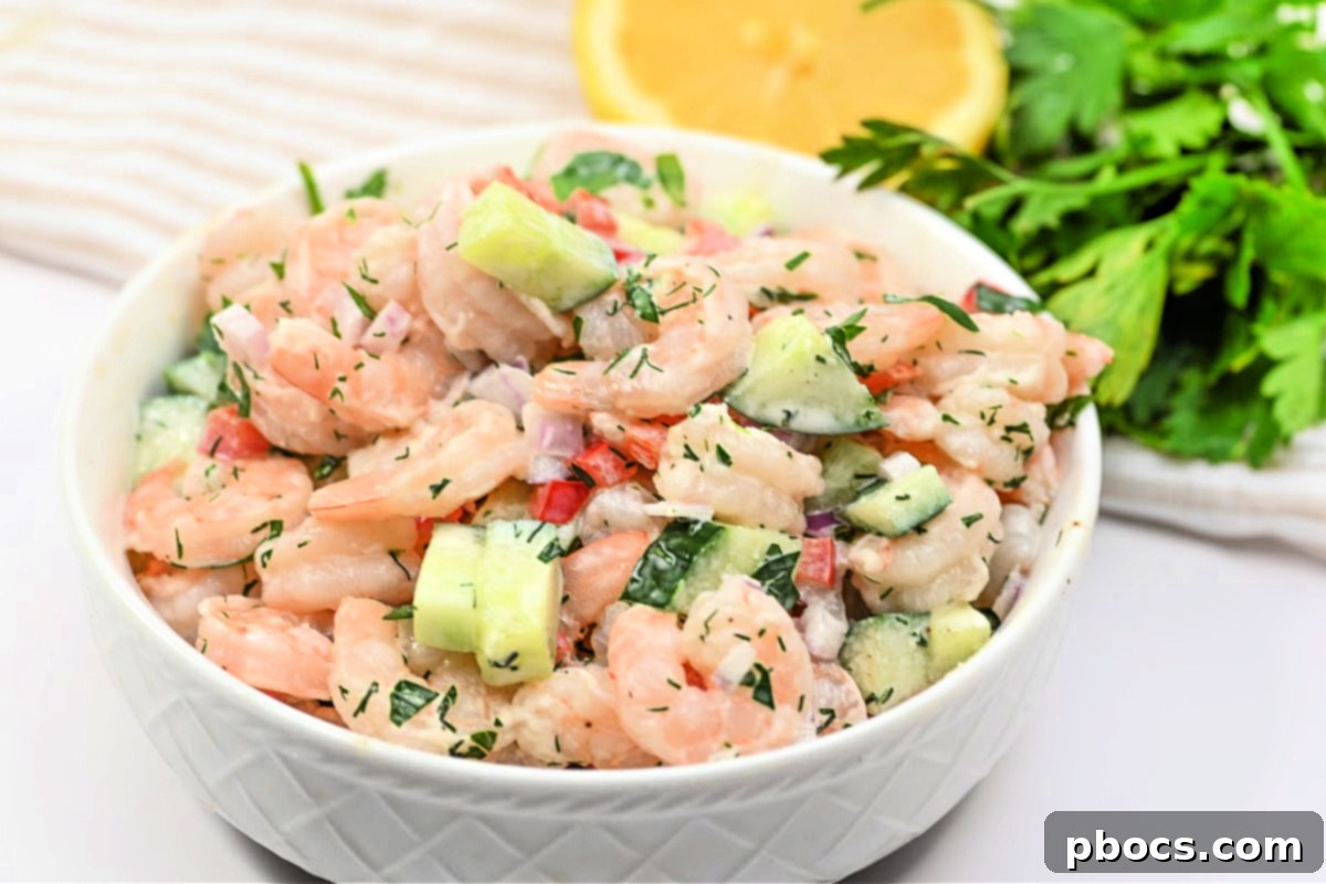 Prepared Creamy Shrimp and Cucumber Salad in a bowl with ingredients