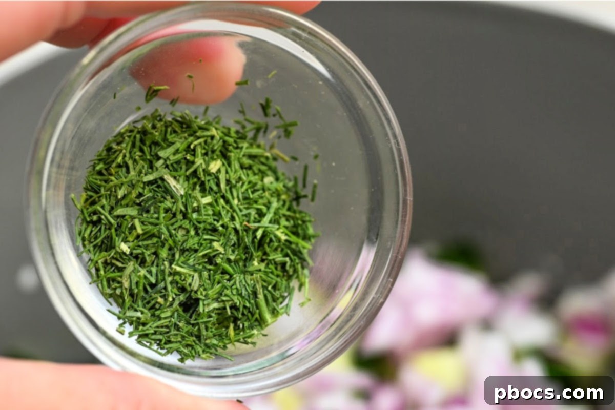 Fresh dill being added to salad ingredients