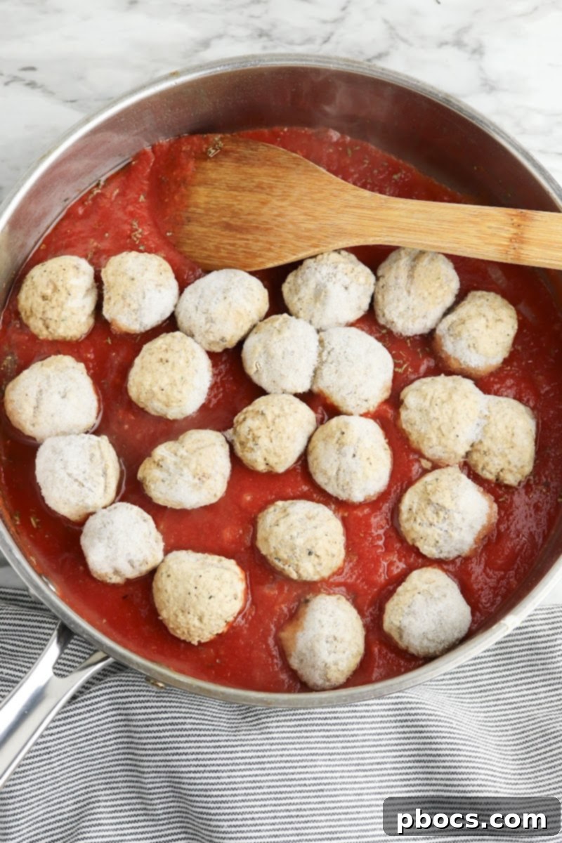 Baking meatballs in marinara sauce in a skillet