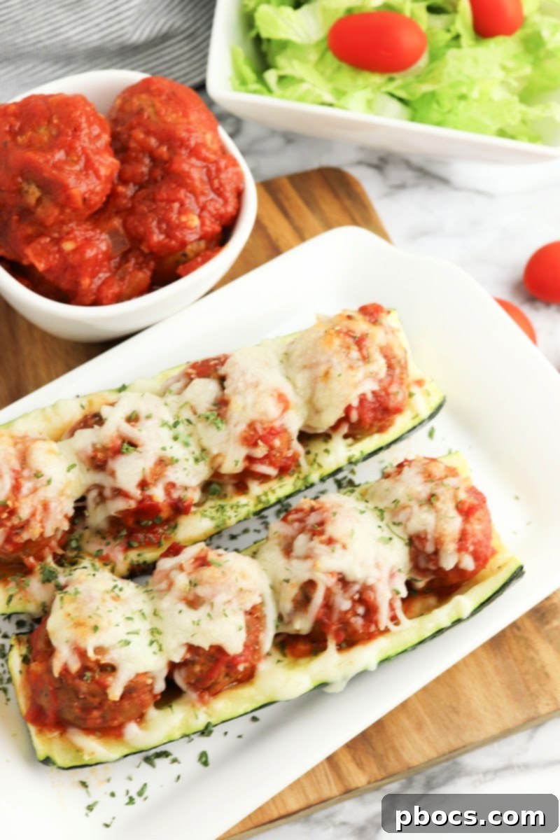 Low-Carb Meatball Zucchini Boats with marinara sauce and cheese