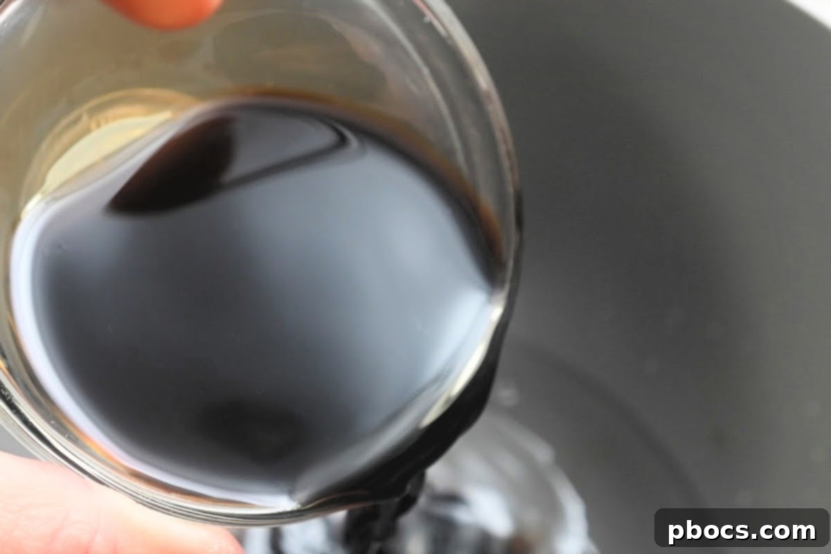 Cabbage cooking in a skillet with pork liquid