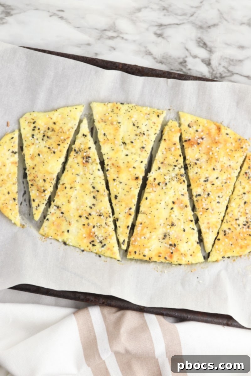 Slicing a freshly baked Keto Cottage Cheese Flatbread into triangles