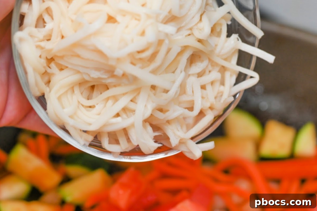 Adding noodles to the pan