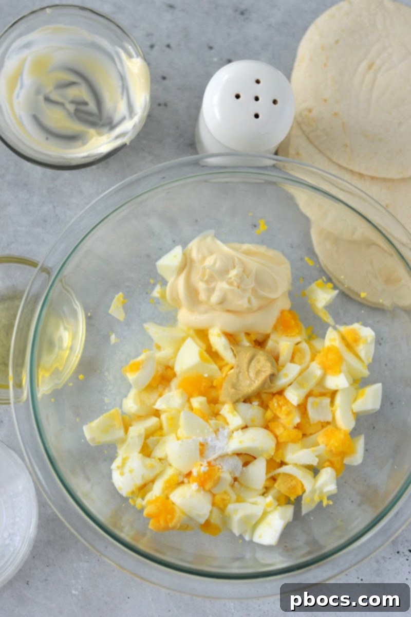 Mixing the egg salad ingredients in a bowl