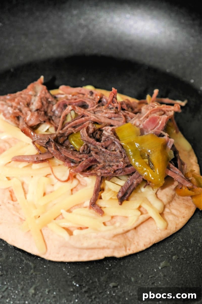 Adding beef to the tortilla with cheese
