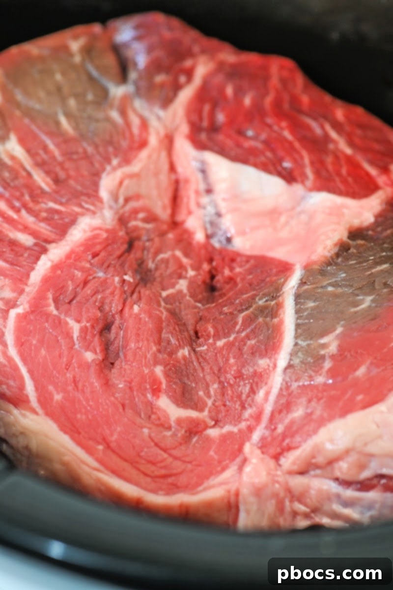 Placing the beef roast in the slow cooker