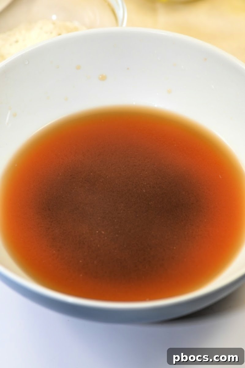 Whisking beef broth base and water