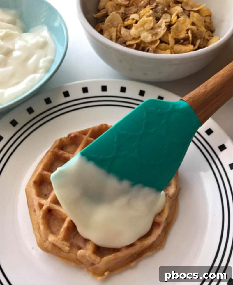Layering bananas, yogurt, and cereal on a waffle