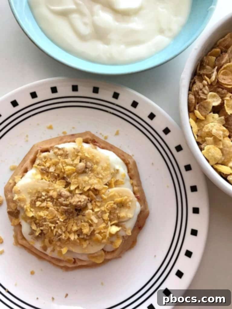 Layering cereal on top of fruit and yogurt