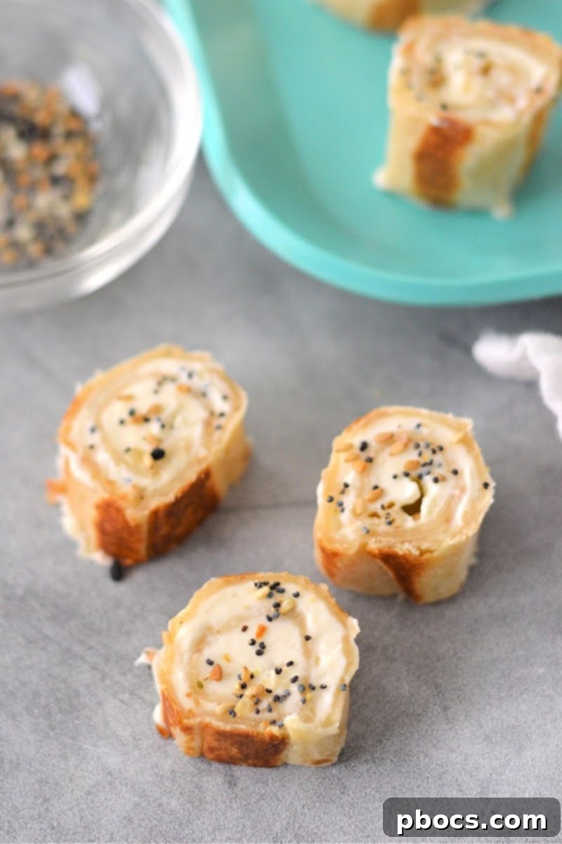 Keto Cream Cheese Bagel Poppers 4 Keto Cream Cheese Bagel Bites arranged artfully on a serving dish, highlighting their pinwheel shape.
