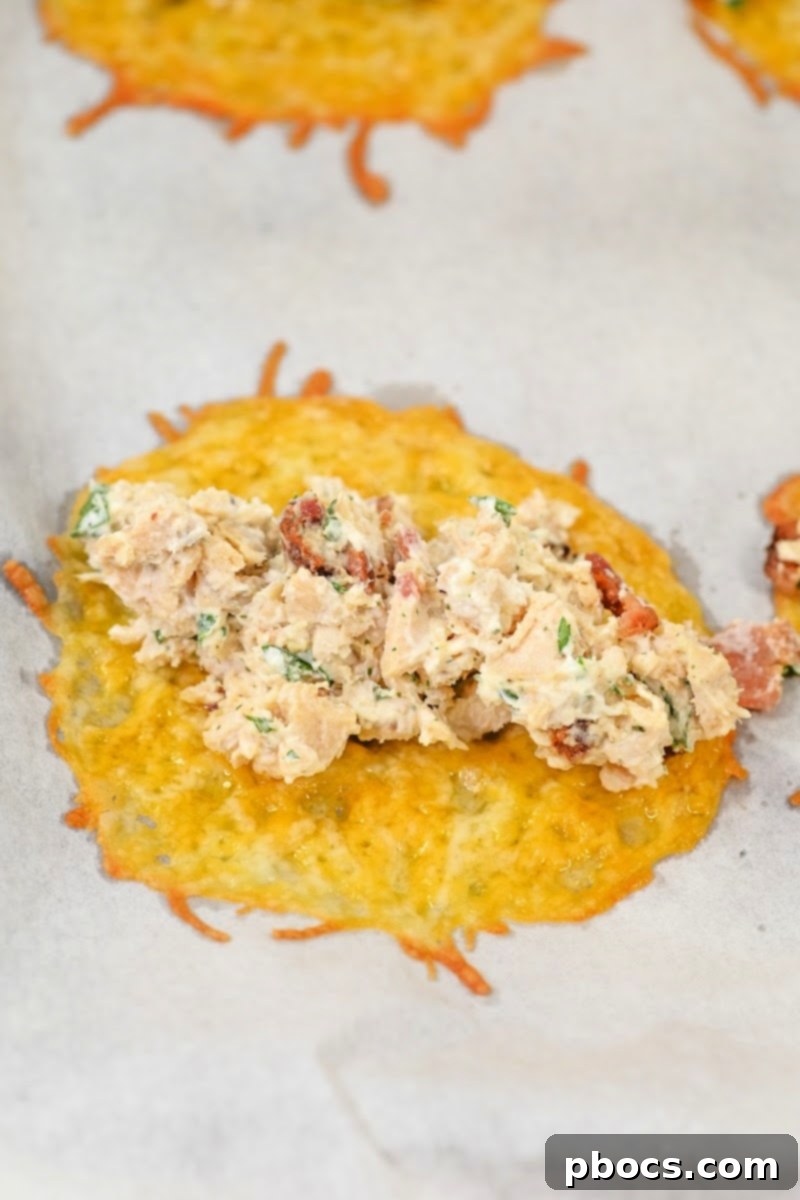 Keto Chicken Bacon Ranch Pinwheels 12 Adding chicken filling to baked cheese