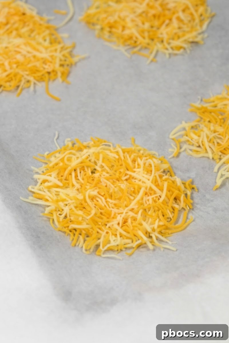 Keto Chicken Bacon Ranch Pinwheels 9 Shredded cheese on parchment paper before baking