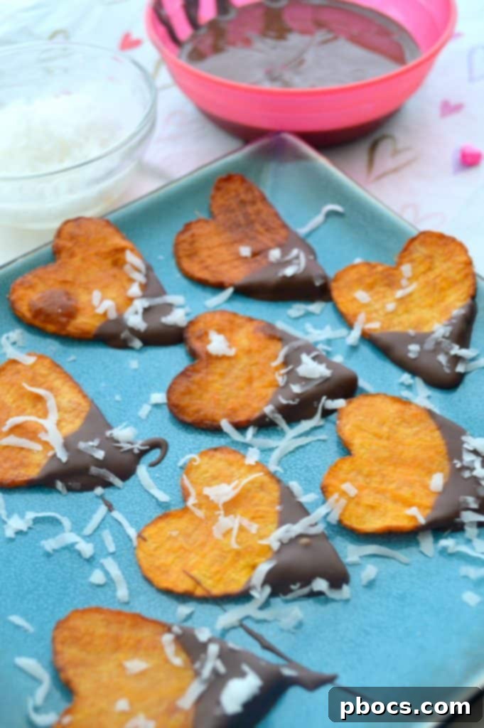 Dipping a sweet potato heart into smooth, melted chocolate.