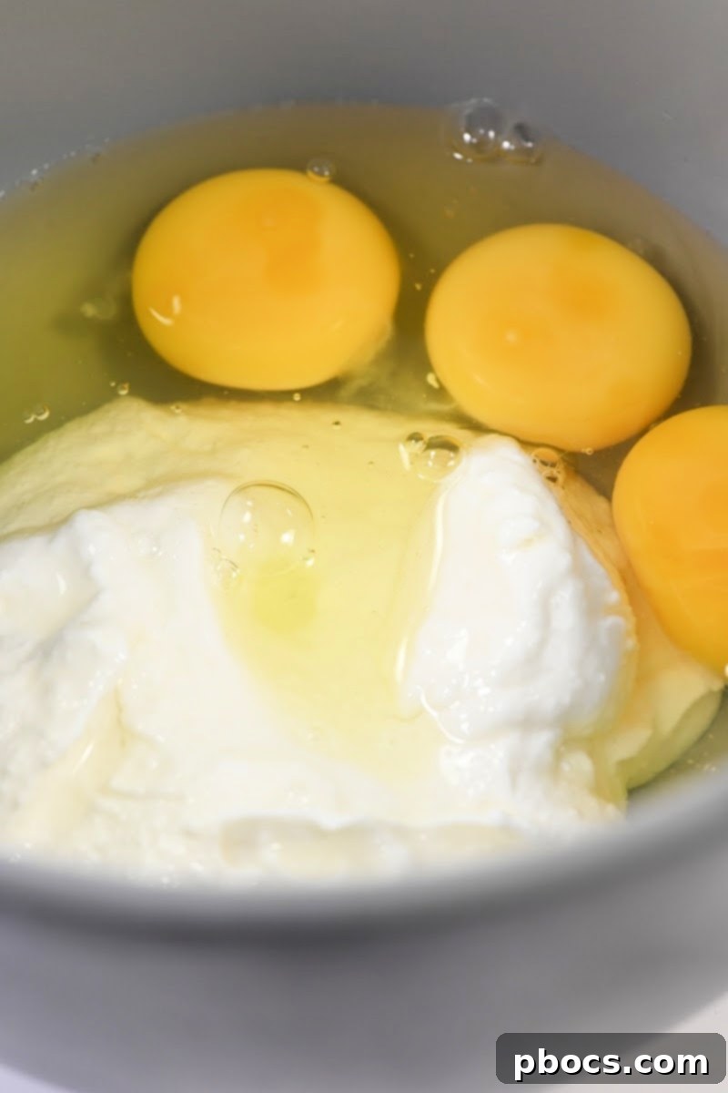 Keto Pizza Poppers 10 Mixing eggs and pureed cottage cheese with other ingredients