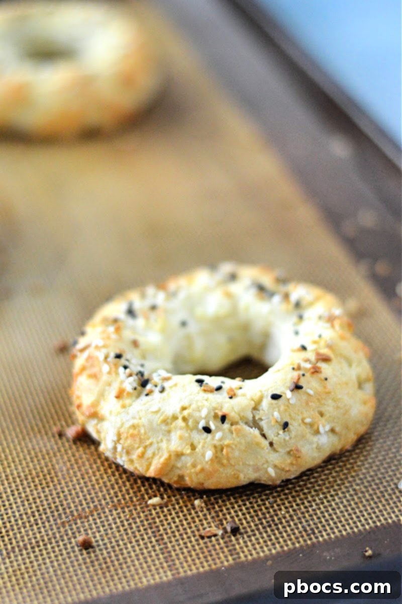 Keto Cottage Cheese Bagel sliced in half with cream cheese and chives.