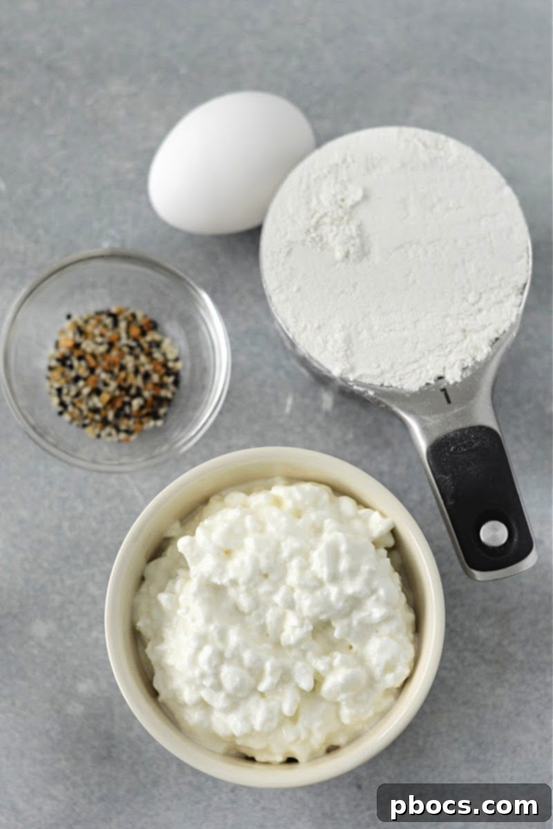 Ingredients laid out for Keto Cottage Cheese Bagels: cottage cheese, keto self-rising flour, egg, and everything bagel seasoning.
