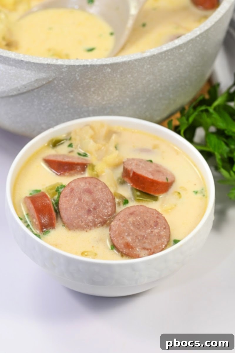 Meal prep containers with Keto Creamy Kielbasa and Cauliflower Soup, ready for storage