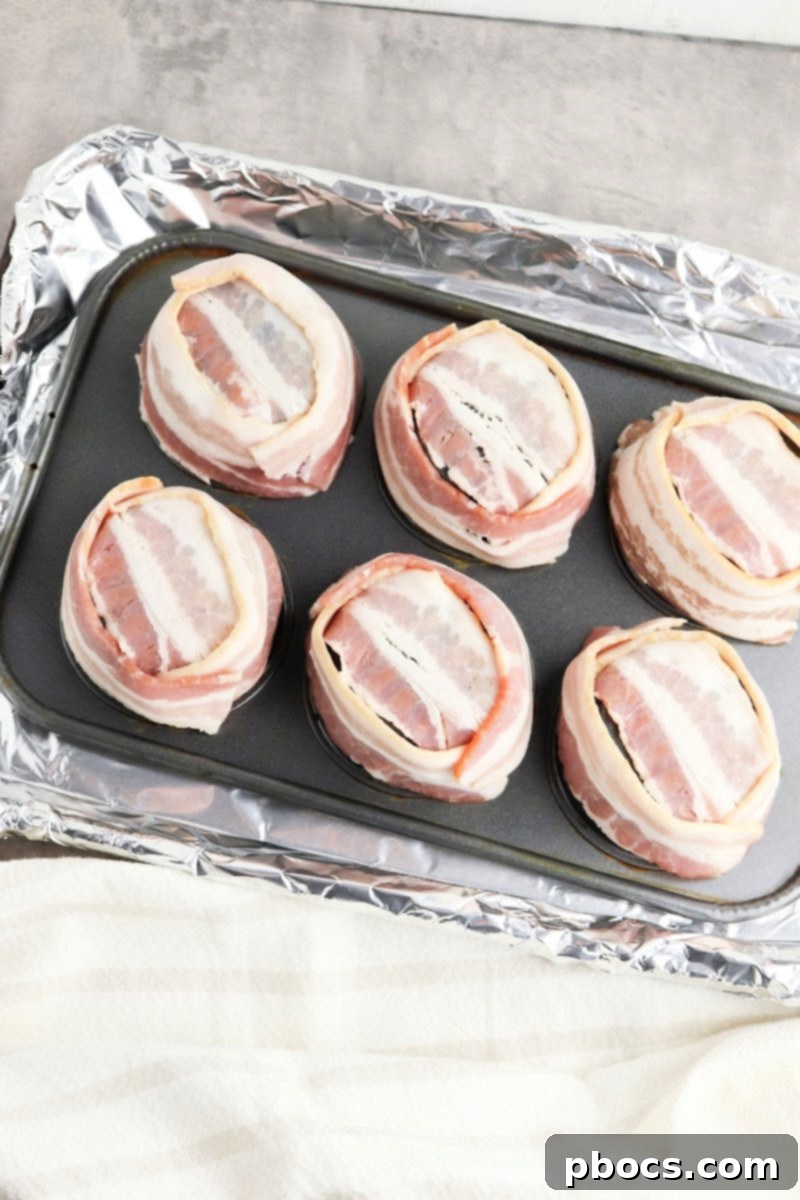 Raw bacon slices arranged on an inverted muffin tin, ready for baking
