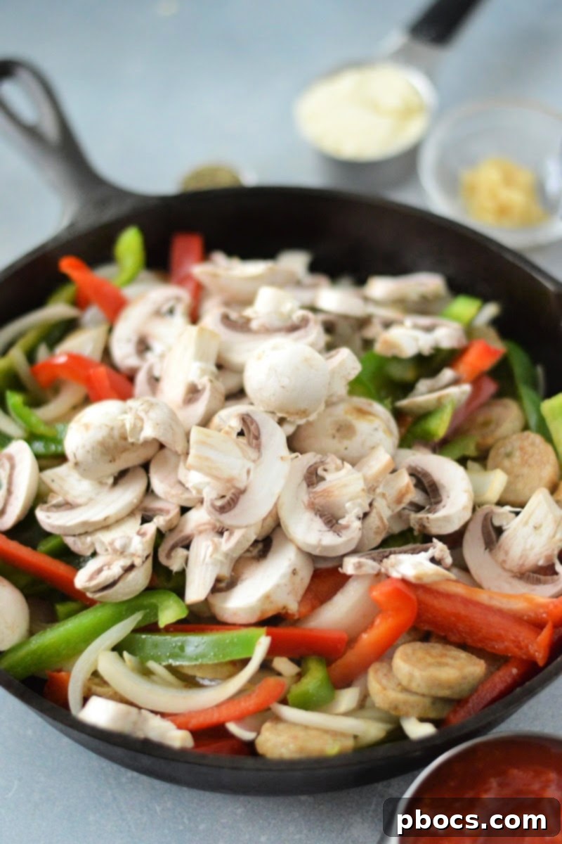 Adding Onions, Peppers, and Mushrooms to the Skillet