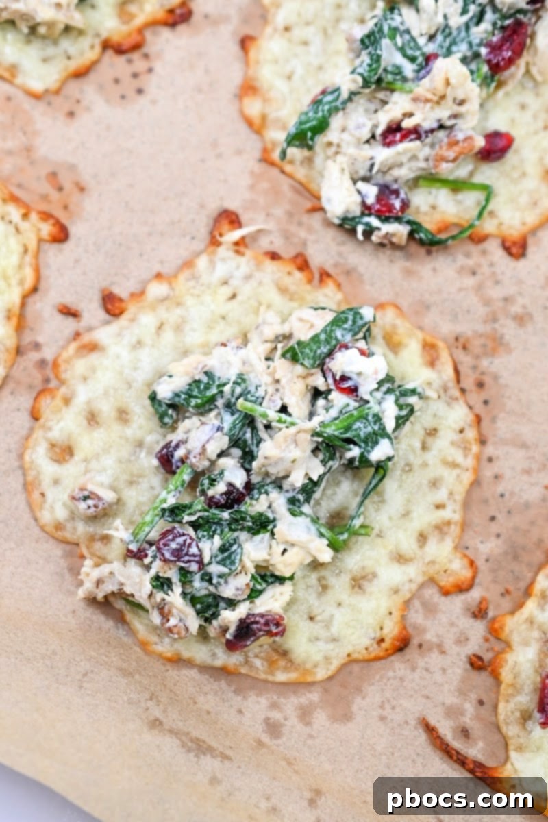 Adding cranberry pecan chicken filling to a baked cheese wrap